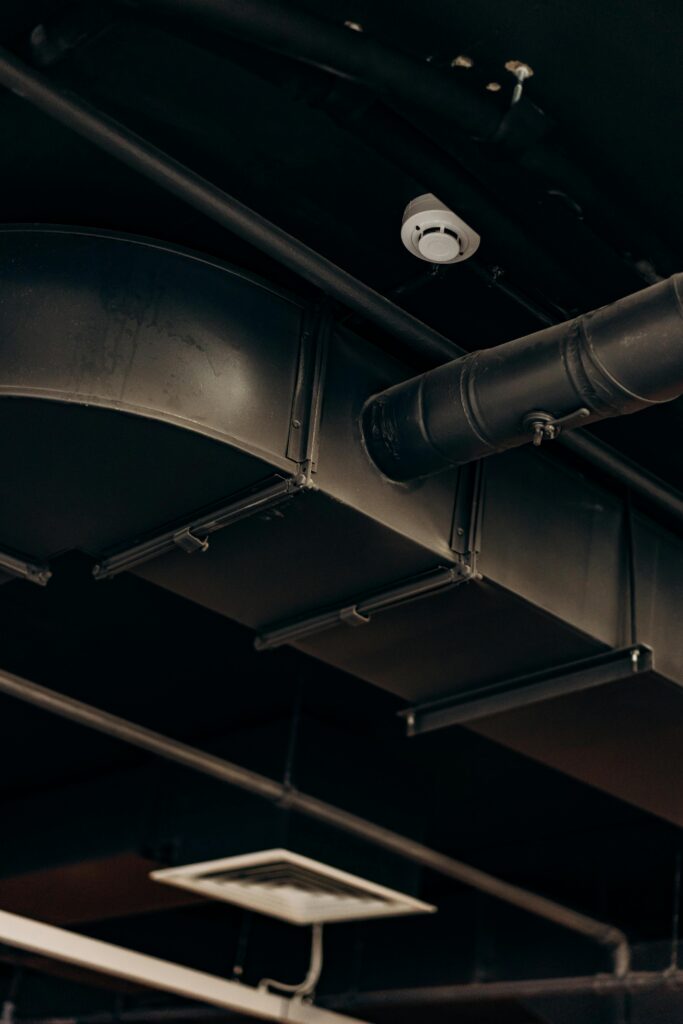 pexels photo 8297856 8297856 Detailed view of industrial air ducts on a ceiling, showcasing modern urban design.
